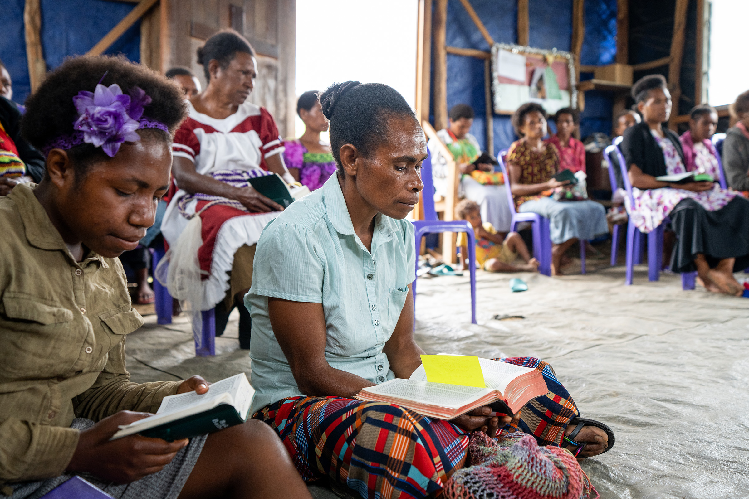 Members of a church plant study the Bible in Papua New Guinea. Photo credit: Jordan and Cassie Timpy