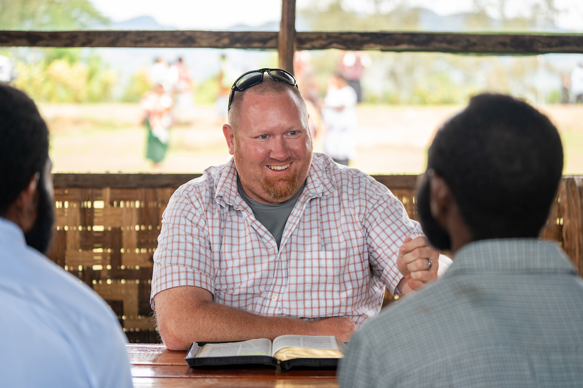 Missionary studying the Bible with local believers in Papua New Guinea
